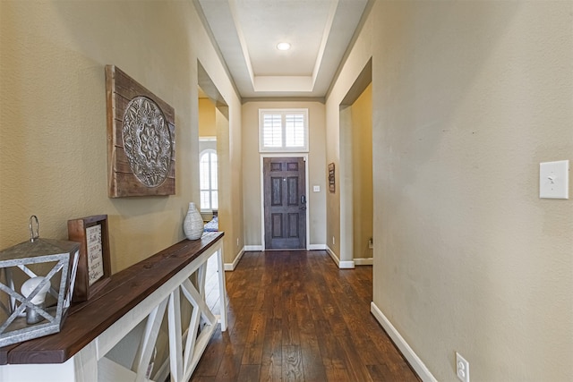 doorway with baseboards and dark wood finished floors