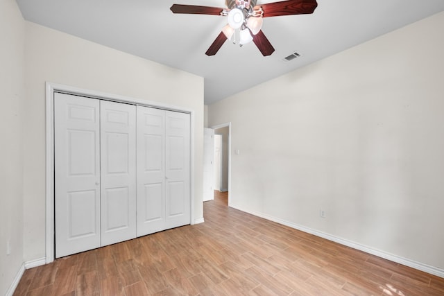 unfurnished bedroom featuring a closet, baseboards, ceiling fan, visible vents, and light wood-type flooring