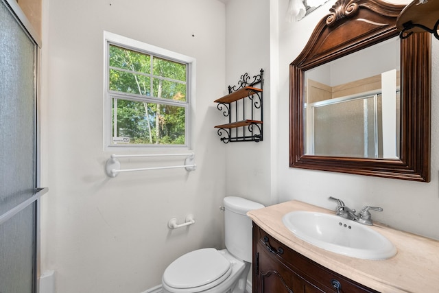 full bath featuring vanity, toilet, and a stall shower