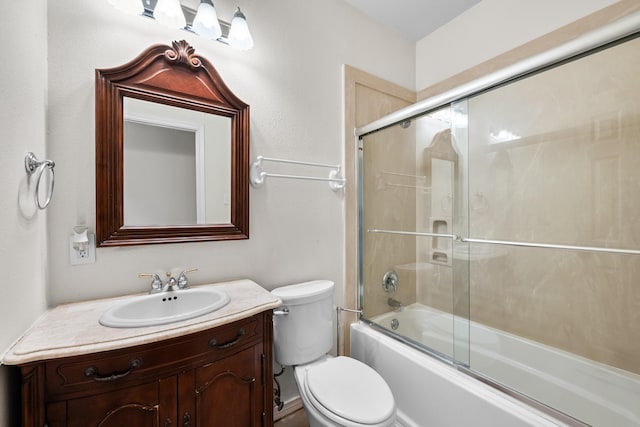 full bathroom featuring toilet, enclosed tub / shower combo, and vanity