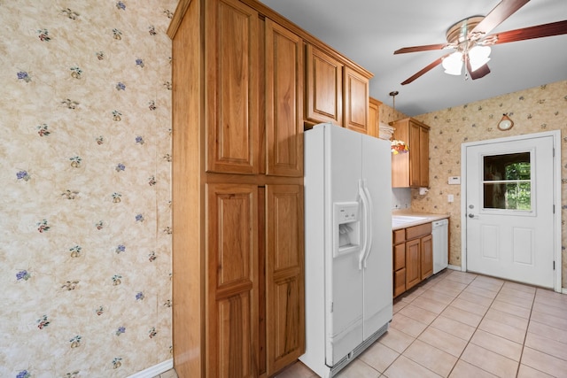 kitchen featuring a ceiling fan, wallpapered walls, light tile patterned floors, white appliances, and light countertops