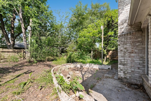 view of yard with fence and a patio