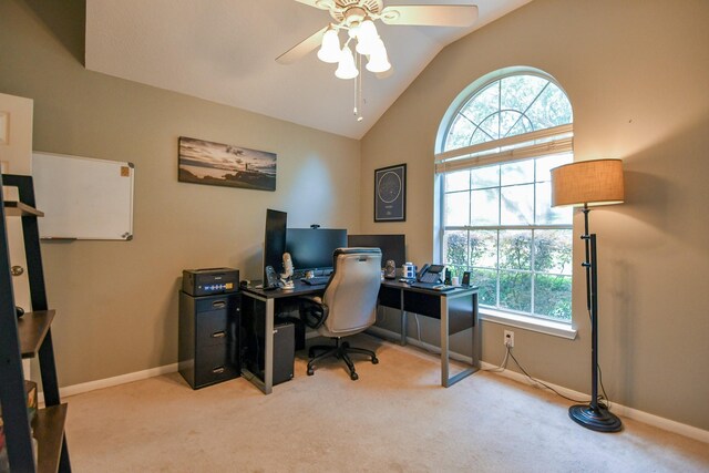 carpeted home office featuring ceiling fan, baseboards, and high vaulted ceiling