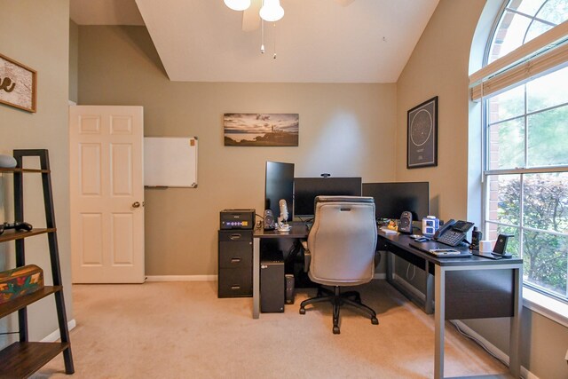 office space featuring carpet floors, ceiling fan, lofted ceiling, and baseboards