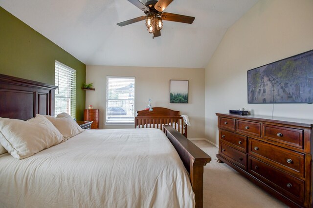bedroom featuring lofted ceiling, light carpet, a ceiling fan, and baseboards