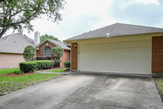 ranch-style home with brick siding, concrete driveway, an attached garage, and a shingled roof