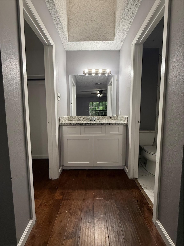 8715 Belle Glen Dr, Houston, TX 77099 - bathroom with hardwood / wood-style flooring, toilet, vanity, and baseboards