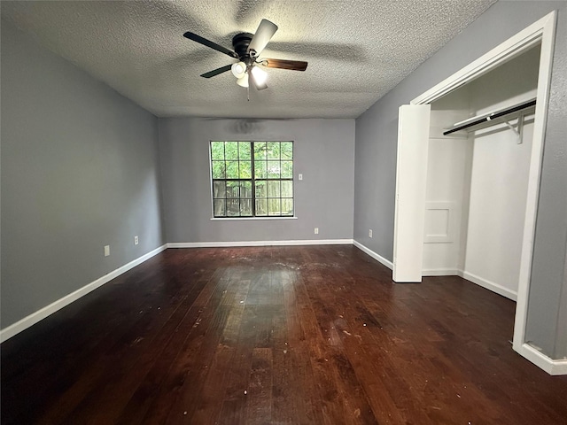 unfurnished bedroom featuring a ceiling fan, a closet, a textured ceiling, baseboards, and wood-type flooring