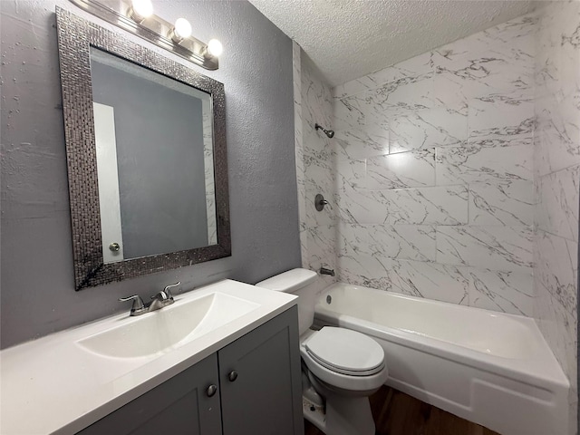 full bathroom featuring toilet, wood finished floors, a textured ceiling, a textured wall, and vanity