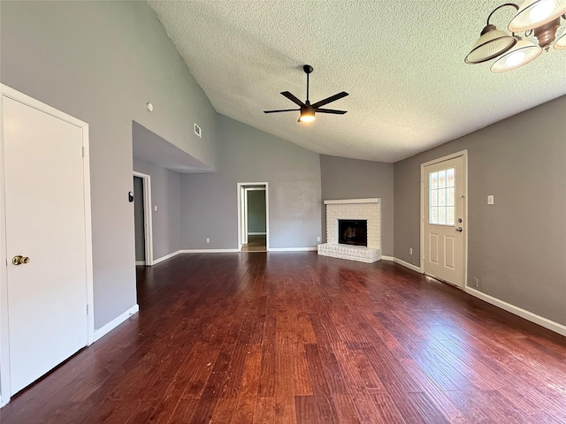 8715 Belle Glen Dr, Houston, TX 77099 - unfurnished living room featuring ceiling fan, a textured ceiling, wood finished floors, a fireplace, and baseboards