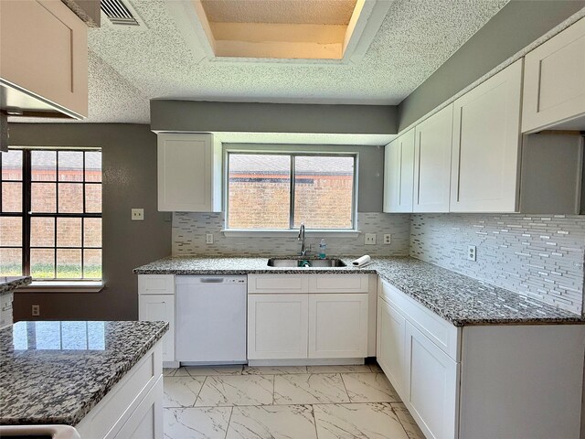 8715 Belle Glen Dr, Houston, TX 77099 - kitchen with white dishwasher, a sink, light marble finish flooring, stone counters, and tasteful backsplash