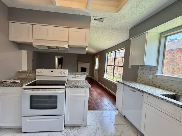 8715 Belle Glen Dr, Houston, TX 77099 - kitchen with white appliances, white cabinetry, light marble finish floors, a peninsula, and light stone counters