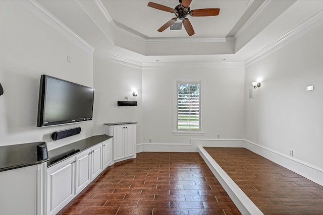 1006 Cross Hollow Ln, Katy, TX 77494 - unfurnished living room with ornamental molding, dark wood-style flooring, a ceiling fan, and a raised ceiling