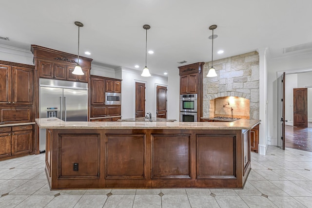 1006 Cross Hollow Ln, Katy, TX 77494 - kitchen with crown molding, light stone counters, built in appliances, and a large island