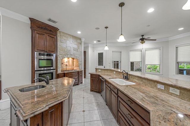 1006 Cross Hollow Ln, Katy, TX 77494 - kitchen with crown molding, stainless steel appliances, visible vents, and a sink