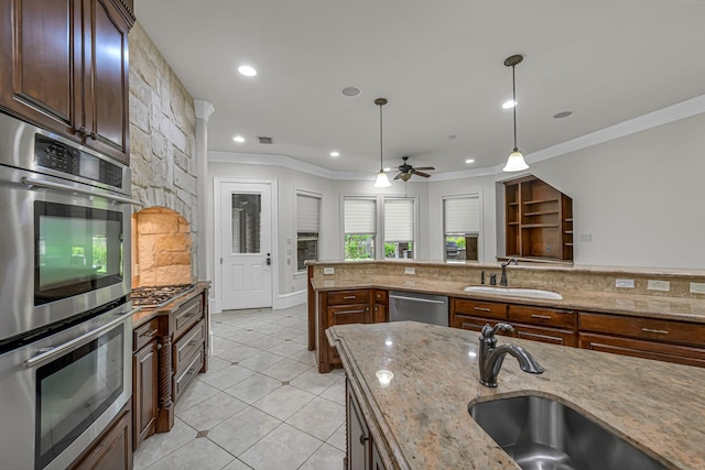 1006 Cross Hollow Ln, Katy, TX 77494 - kitchen with a sink, appliances with stainless steel finishes, crown molding, ceiling fan, and decorative light fixtures