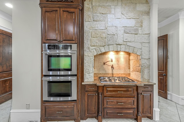 1006 Cross Hollow Ln, Katy, TX 77494 - kitchen featuring light tile patterned floors, stainless steel appliances, crown molding, baseboards, and decorative backsplash
