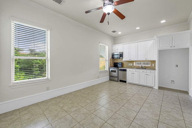 1006 Cross Hollow Ln, Katy, TX 77494 - kitchen with light tile patterned floors, visible vents, crown molding, backsplash, and appliances with stainless steel finishes