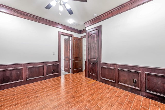 1006 Cross Hollow Ln, Katy, TX 77494 - cinema with crown molding, a ceiling fan, a wainscoted wall, and wood finished floors