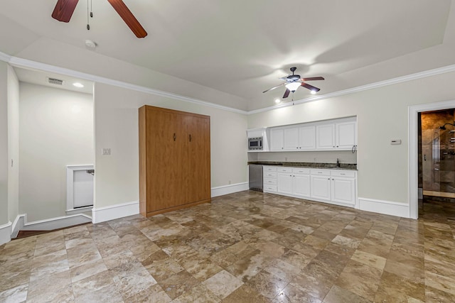1006 Cross Hollow Ln, Katy, TX 77494 - unfurnished living room with ceiling fan, baseboards, stone finish flooring, and ornamental molding