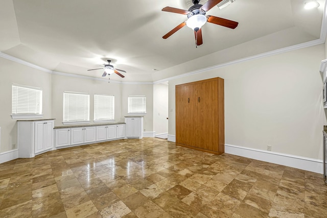 1006 Cross Hollow Ln, Katy, TX 77494 - unfurnished living room featuring ceiling fan, baseboards, a raised ceiling, and ornamental molding