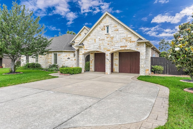1006 Cross Hollow Ln, Katy, TX 77494 - french provincial home featuring stone siding, fence, and a front yard