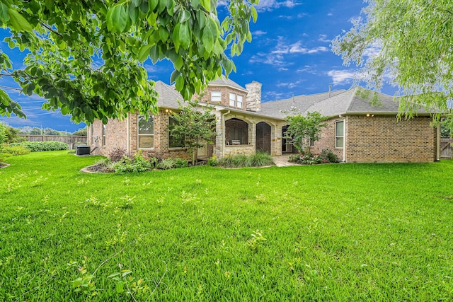 1006 Cross Hollow Ln, Katy, TX 77494 - view of front of property featuring brick siding, a chimney, a shingled roof, and central AC