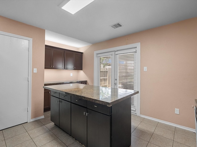 7914 Cypress Edge Dr, Cypress, TX 77433 - kitchen with baseboards, light tile patterned floors, and a kitchen island