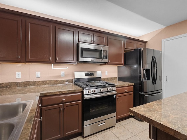 7914 Cypress Edge Dr, Cypress, TX 77433 - kitchen featuring appliances with stainless steel finishes, light tile patterned flooring, dark brown cabinets, and a sink