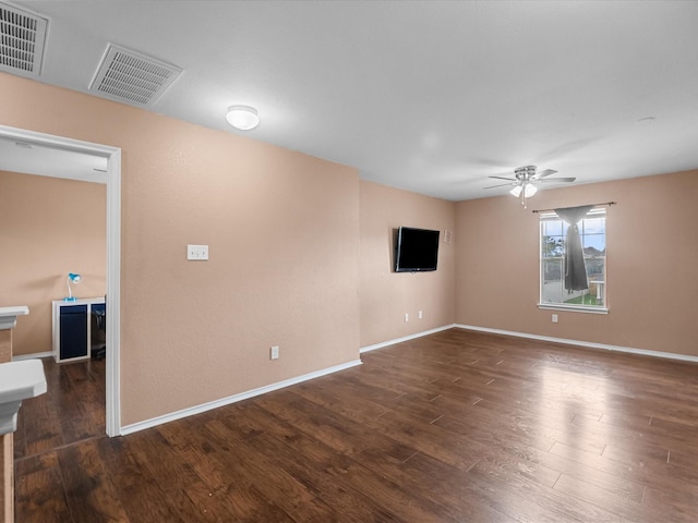 7914 Cypress Edge Dr, Cypress, TX 77433 - empty room with a ceiling fan, dark wood-style flooring, and baseboards