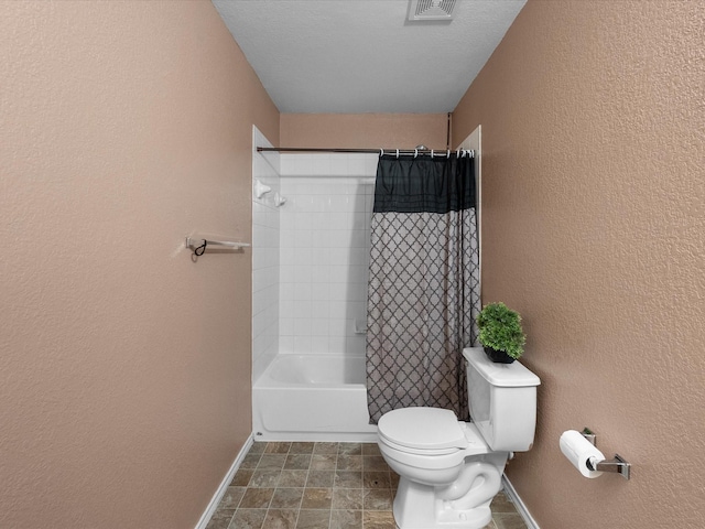 7914 Cypress Edge Dr, Cypress, TX 77433 - bathroom featuring a textured wall, baseboards, toilet, and shower / bath combination with curtain
