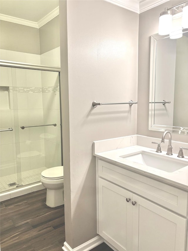 6314 1st St, Bellaire, TX 77401 - bathroom featuring ornamental molding, wood finished floors, a shower stall, toilet, and vanity