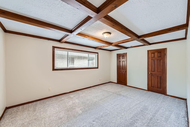 empty room with a textured ceiling, baseboards, beam ceiling, and light colored carpet