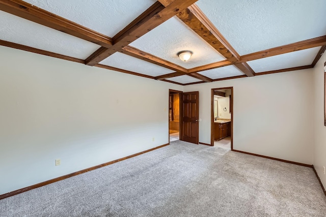 spare room featuring a textured ceiling, light colored carpet, beam ceiling, and coffered ceiling