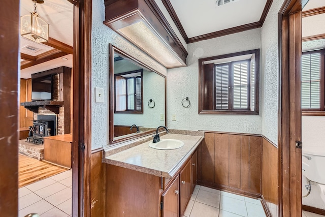 half bathroom with tile patterned flooring, ornamental molding, and a textured wall