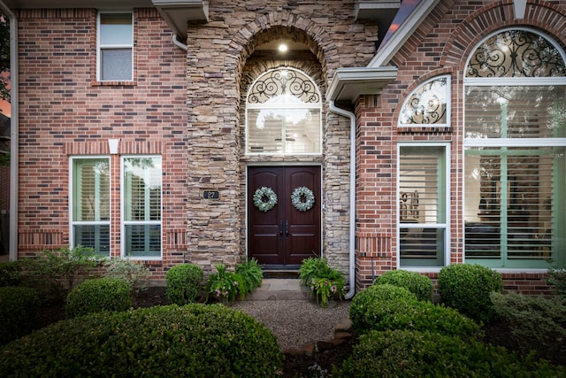 doorway to property with brick siding