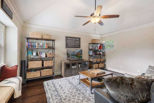 living room with baseboards, wood finished floors, a ceiling fan, and ornamental molding