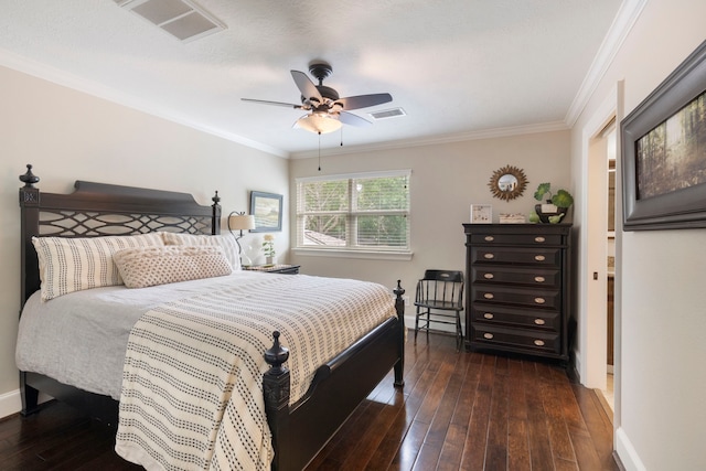 bedroom featuring crown molding, baseboards, hardwood / wood-style floors, and visible vents