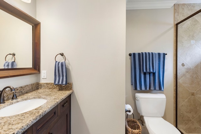 full bath featuring crown molding, toilet, a shower stall, and vanity