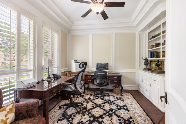 office area featuring ornamental molding, a decorative wall, ceiling fan, and dark wood-style floors