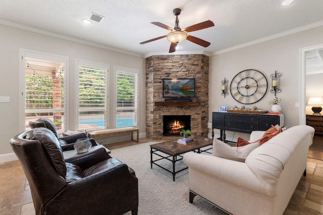 living room featuring stone finish floor, a stone fireplace, ornamental molding, visible vents, and ceiling fan