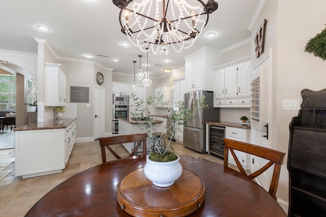 dining room featuring baseboards, recessed lighting, crown molding, and beverage cooler