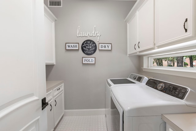 clothes washing area featuring washer and clothes dryer, cabinet space, visible vents, tile patterned flooring, and baseboards