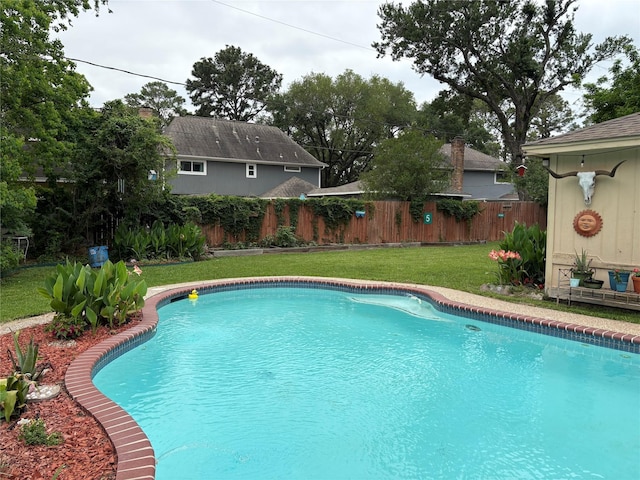 view of swimming pool featuring a yard, a fenced in pool, and fence private yard