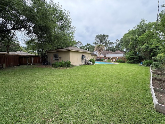 view of yard featuring a fenced in pool and a fenced backyard