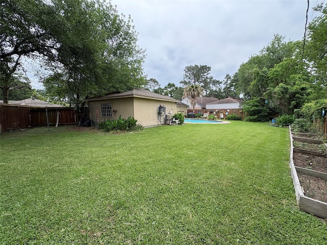 view of yard with a fenced in pool and a fenced backyard