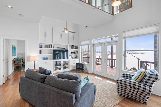 650 Dove Is, Livingston, TX 77351 - living room featuring a high ceiling, french doors, light wood-style flooring, and ceiling fan