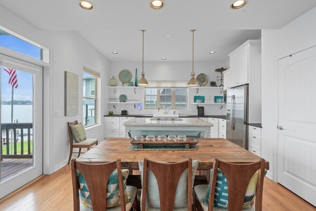 650 Dove Is, Livingston, TX 77351 - kitchen with open shelves, plenty of natural light, stainless steel fridge, and recessed lighting