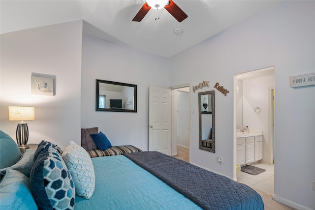 bedroom with a ceiling fan, baseboards, ensuite bath, and light tile patterned flooring