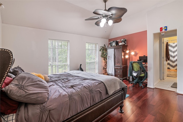 bedroom with lofted ceiling, hardwood / wood-style floors, and a ceiling fan